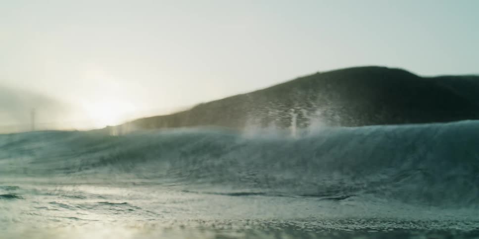 A large wave hits the shore