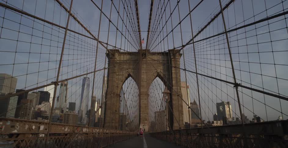 A large bridge leads to a city in the distance