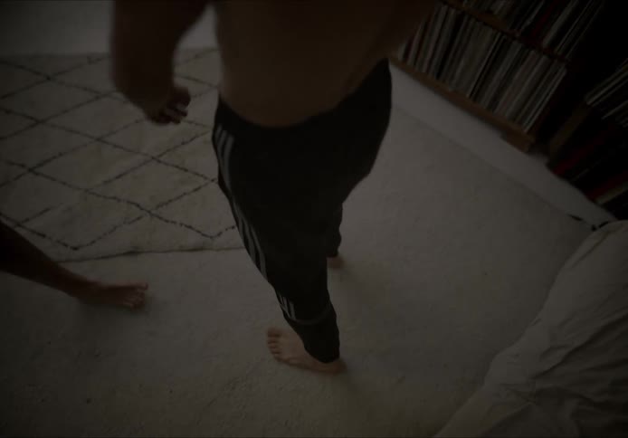 Two barefoot men dancing together