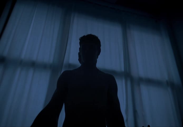 Silhouette of two men raising their arms and dancing