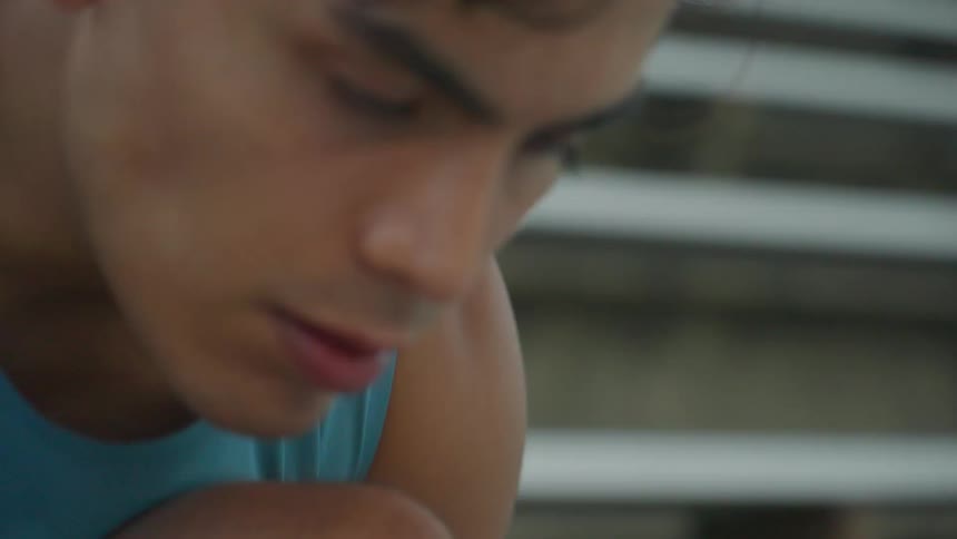 A runner tying his shoelace then standing up