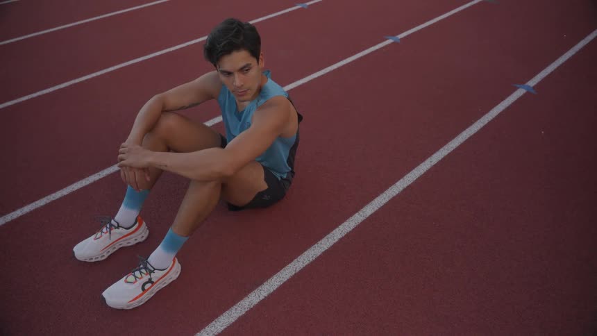 Runner sitting on an athletics track