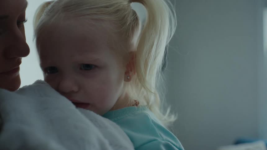 A mother is holding her daughter