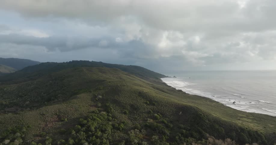 Ocean tides come ashore near a mountain range