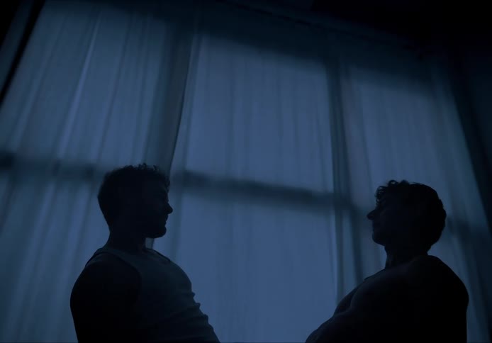 Two men lovers dancing in a dark room