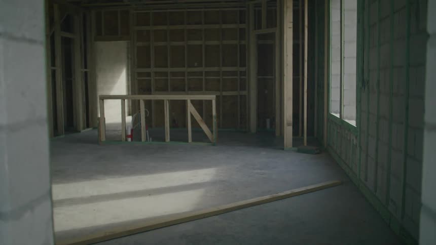 A woodenframed room with a concrete floor and windows letting in sunlight