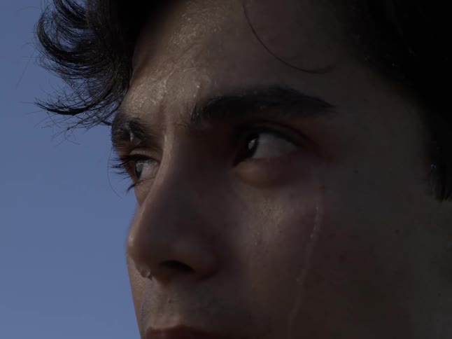 A teenager heavily sweats outdoors
