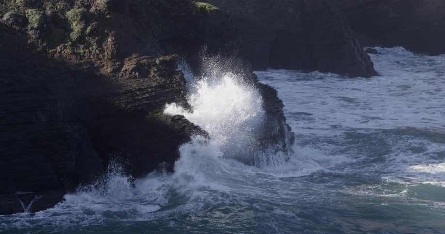 Sea waves breaking on a coast full of high rocks
