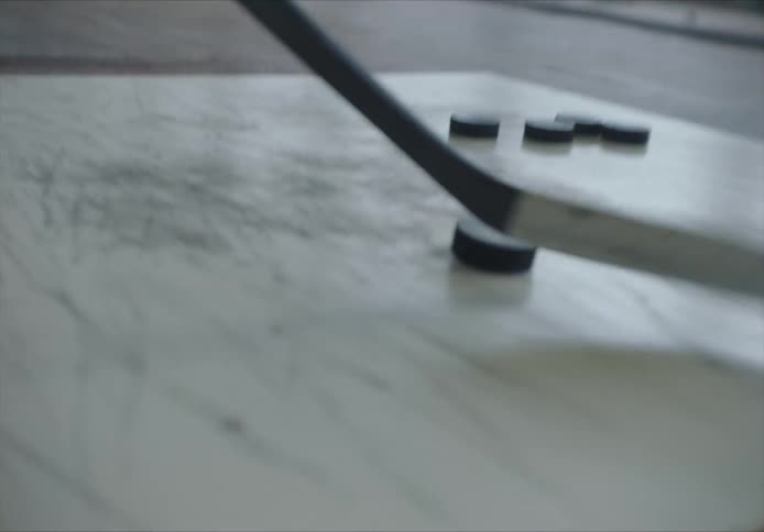 With a stick on a court practicing hockey