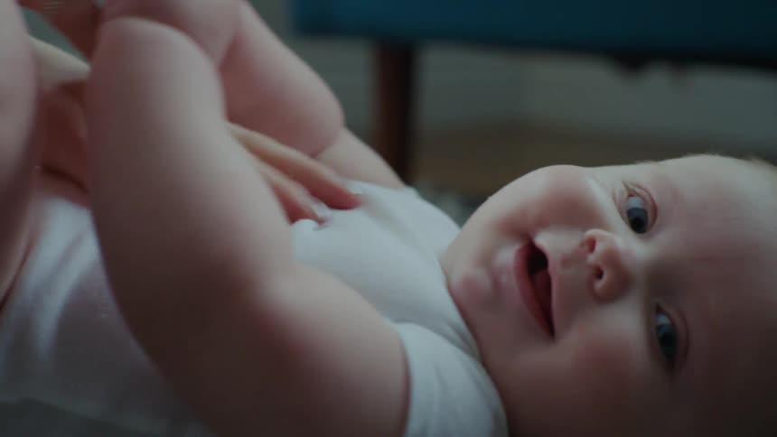 A mother tickles her babys stomach