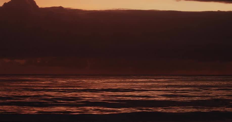 Landscape of the coast sea and a reddish sky