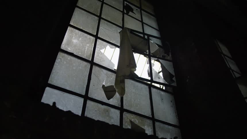 Broken window in a room with low lighting