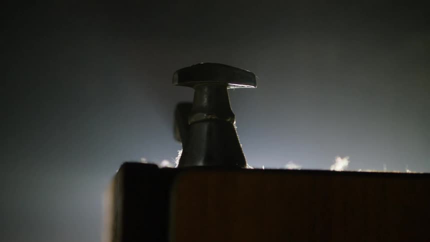 Cross on a metal tap in a water fountain