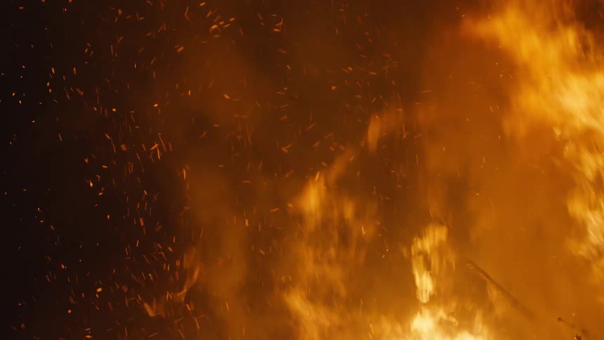 Flames and smoke from a bonfire at night