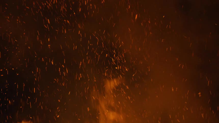 Sparks fly off of a flame