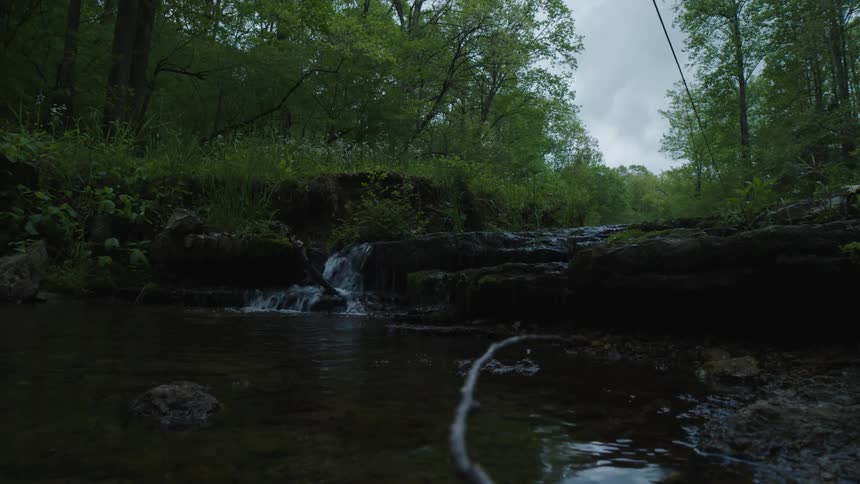 A creek generates a small waterfall
