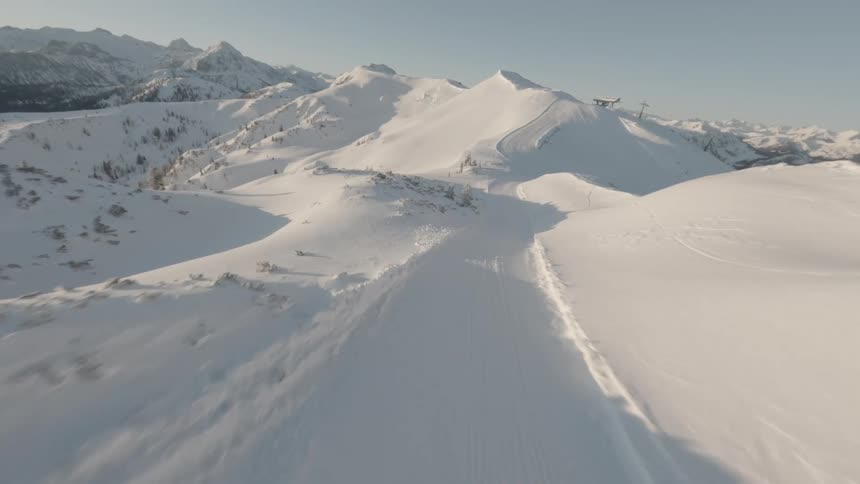 Aerial of a mountain ski slope during winter at dawn