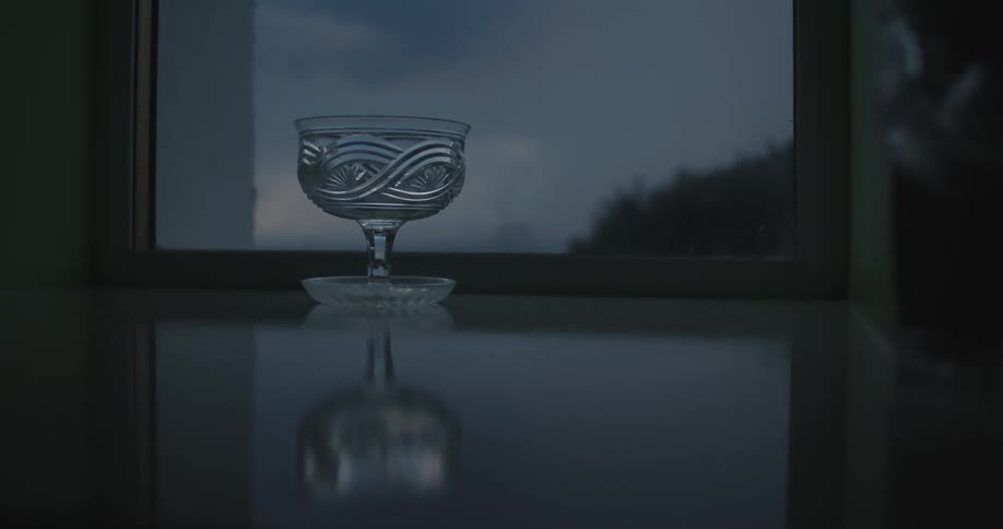 Crystal glass on a table next to a window