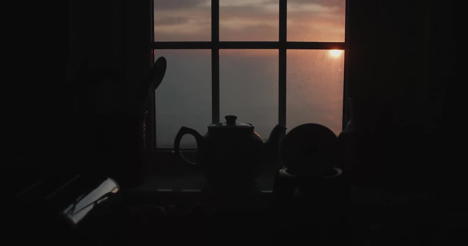 View from the kitchen window with the sun rising over the horizon under the sea
