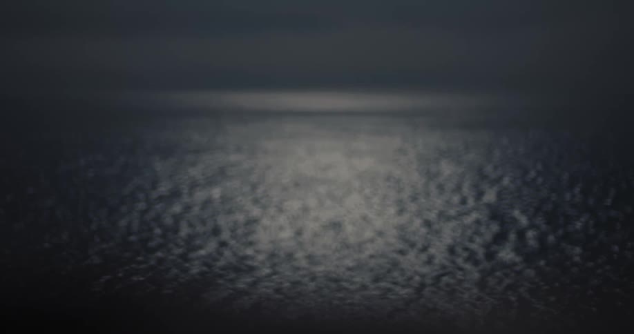 Ocean waves move in the night