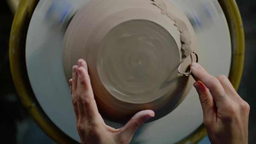 Hands of a woman sculpting modeling a clay vase