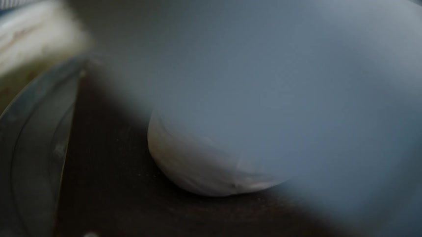 A human hand hitting a soft material and then it starts to rotate on a plate then the person models it to the shape of their hand