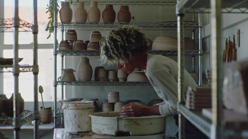 A clip of a lady massaging a clay