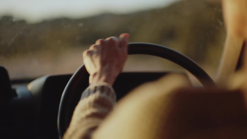 A white woman drives a car