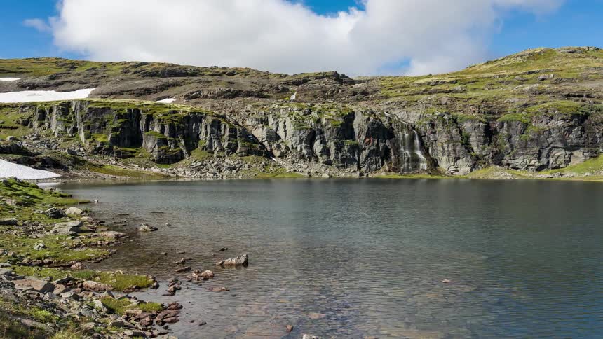A lake lines the mountain range