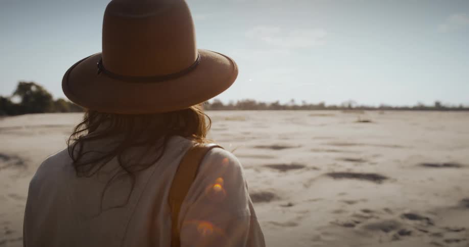 A woman on a sandbar during a hot summer day