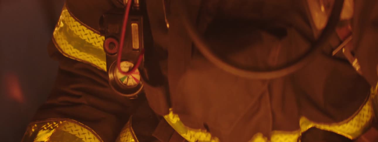 Closeup of a firefighter uniform amidst the flames of a fire
