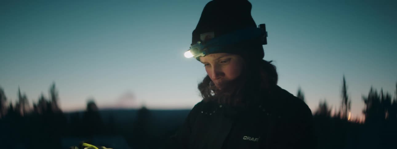 A woman looks at a map then looks around