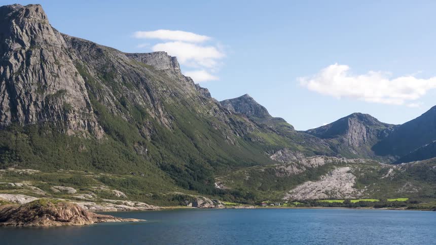 Landscape of geological mountains on the edge of a lake with residential houses