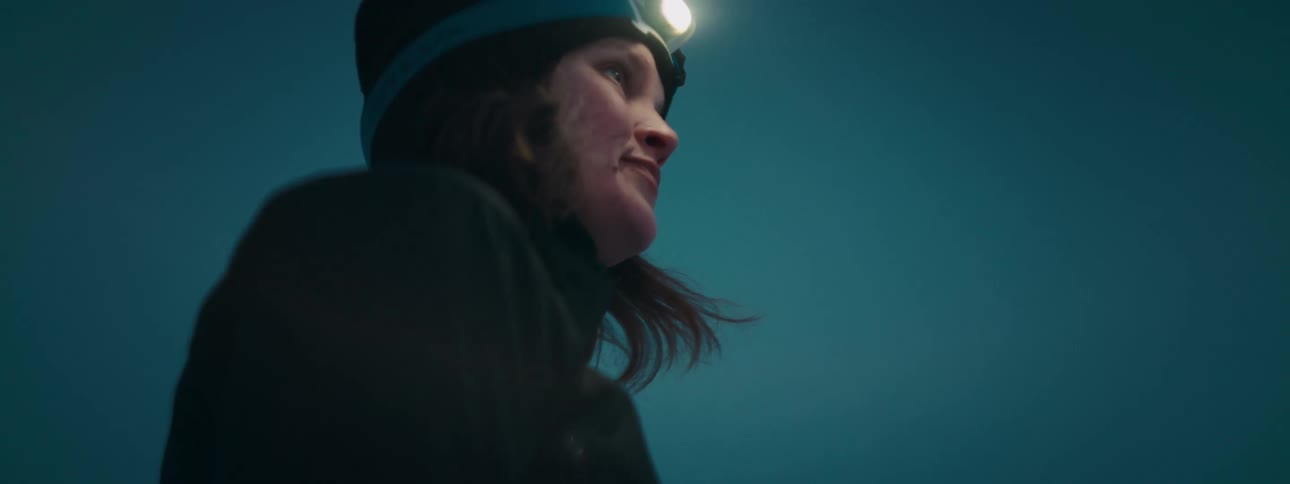 Close up of a womans face with a headlamp