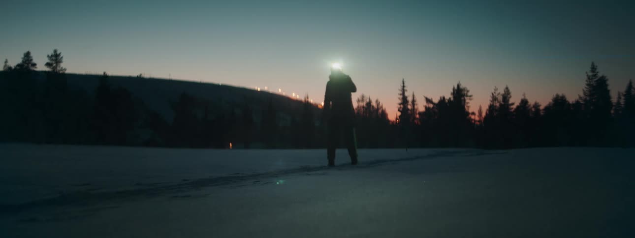 A woman cross country skis in the winter