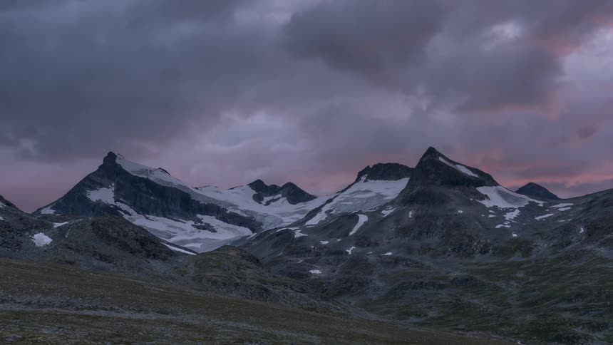 Heavy clouds flow over the mountains