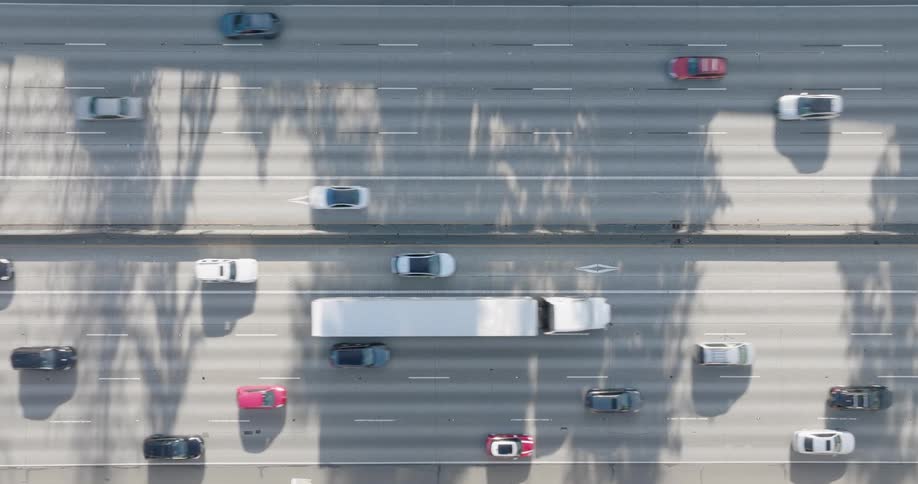 Straight down view of free flowing traffic on a major ten lane freeway