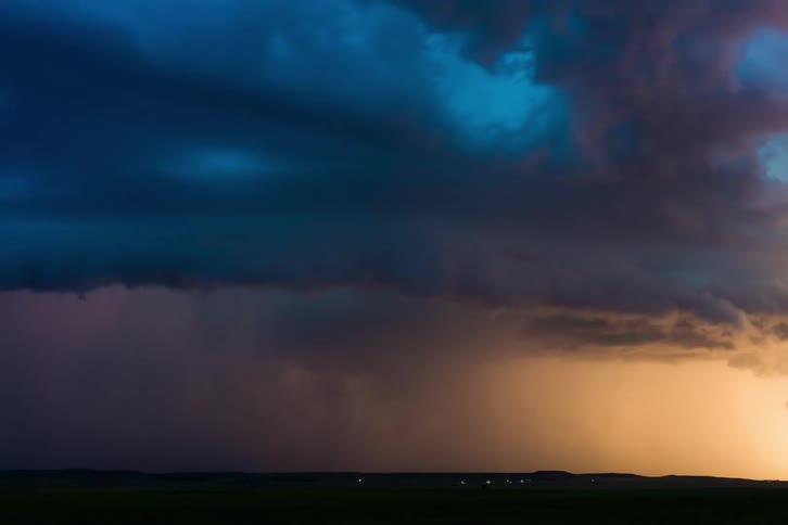 Lightning bolts strike ground as storm clouds swirl