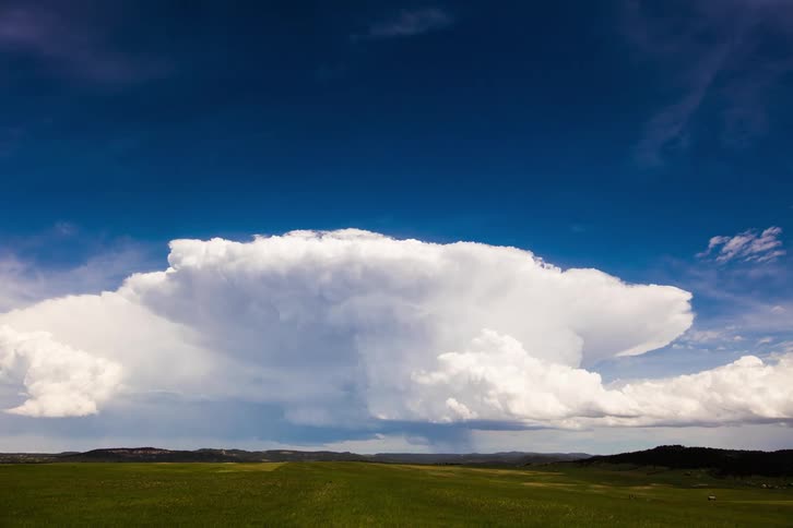 White clouds gather in the blue sky