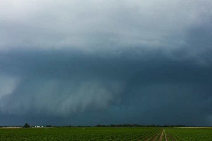Storm clouds move over rural homes and farmland
