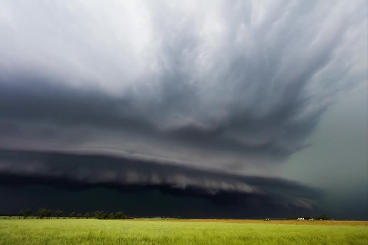 A tornado of dark clouds approached a small rural town