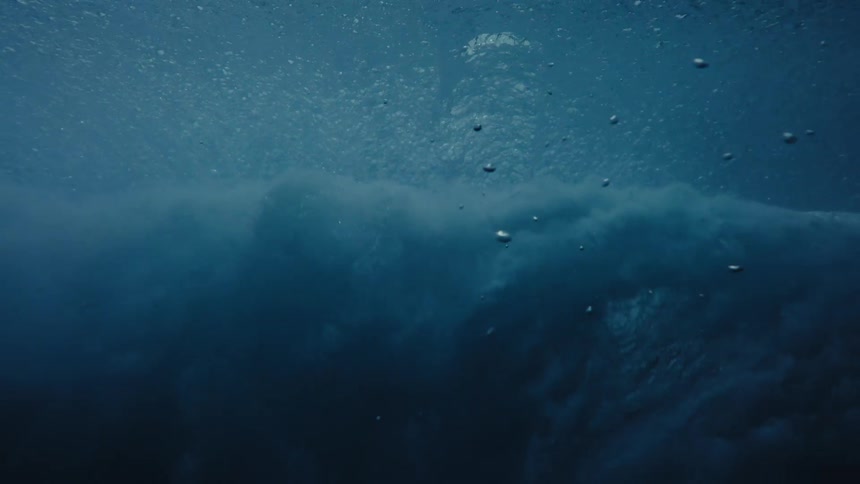 Water waves gently sway beneath the seas surface