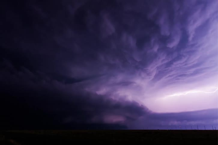A furious gale with thunder in a rural field