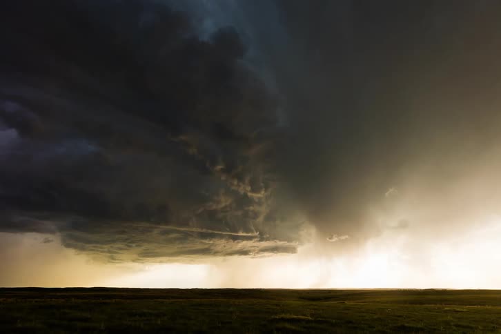 Dark storm clouds move across the sky and turn in rotation