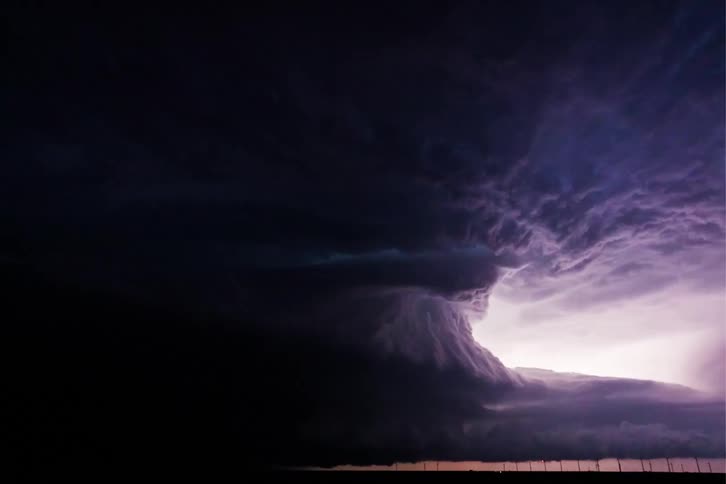 A monster blue supercell flashes at night