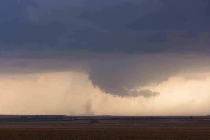 Storm clouds in rotation moving over rural land