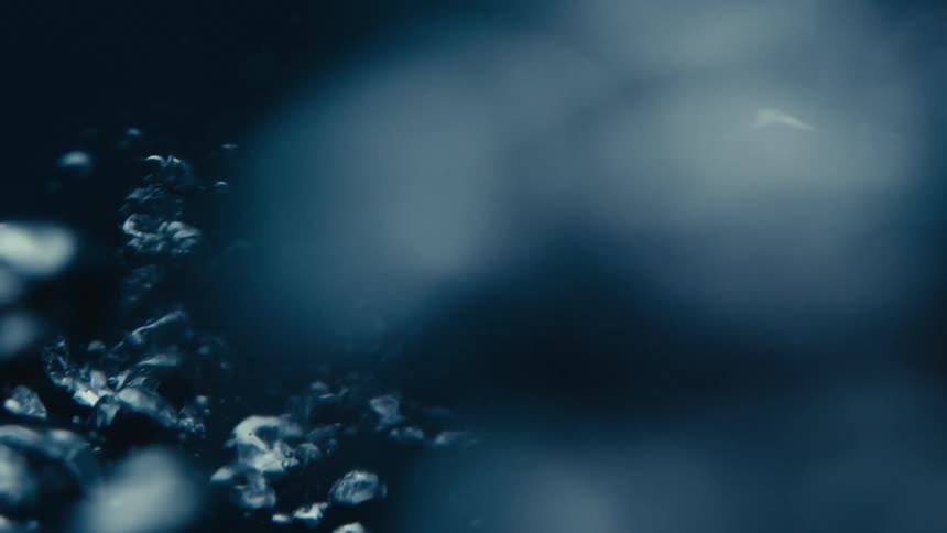 Extreme close up on a spiral moving liquid with bubbles