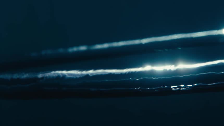 Close up of a ringed air bubble rising to the surface of water