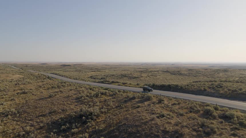 Vehicle drives along highway through countryside during a road trip