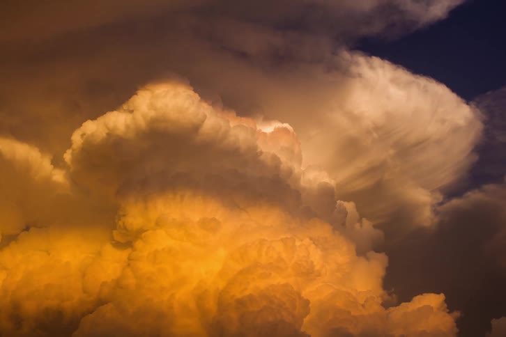 Time lapse of colorful billowing clouds at dusk